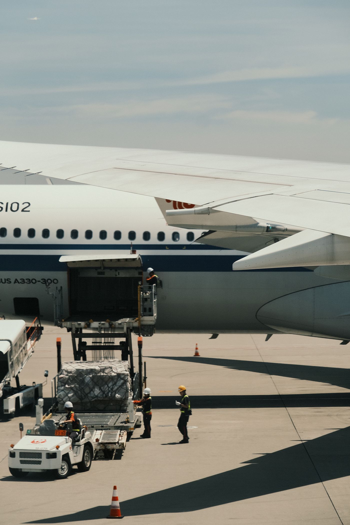 Cargo being loaded into the lower deck of a wide-body aircraft